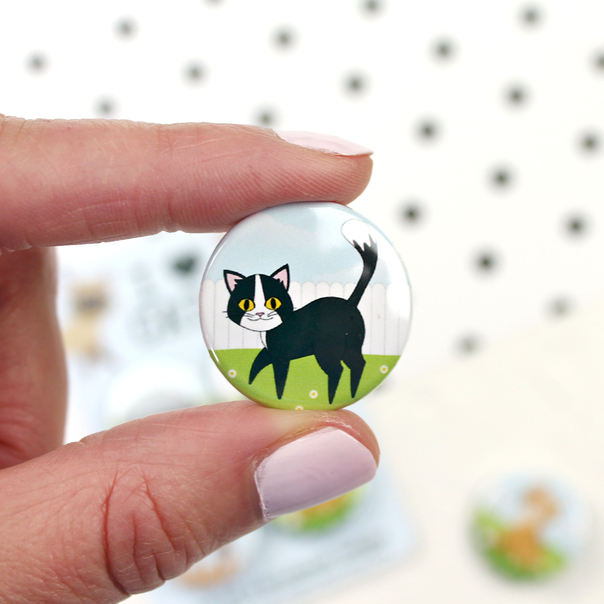 Black and white cat badge