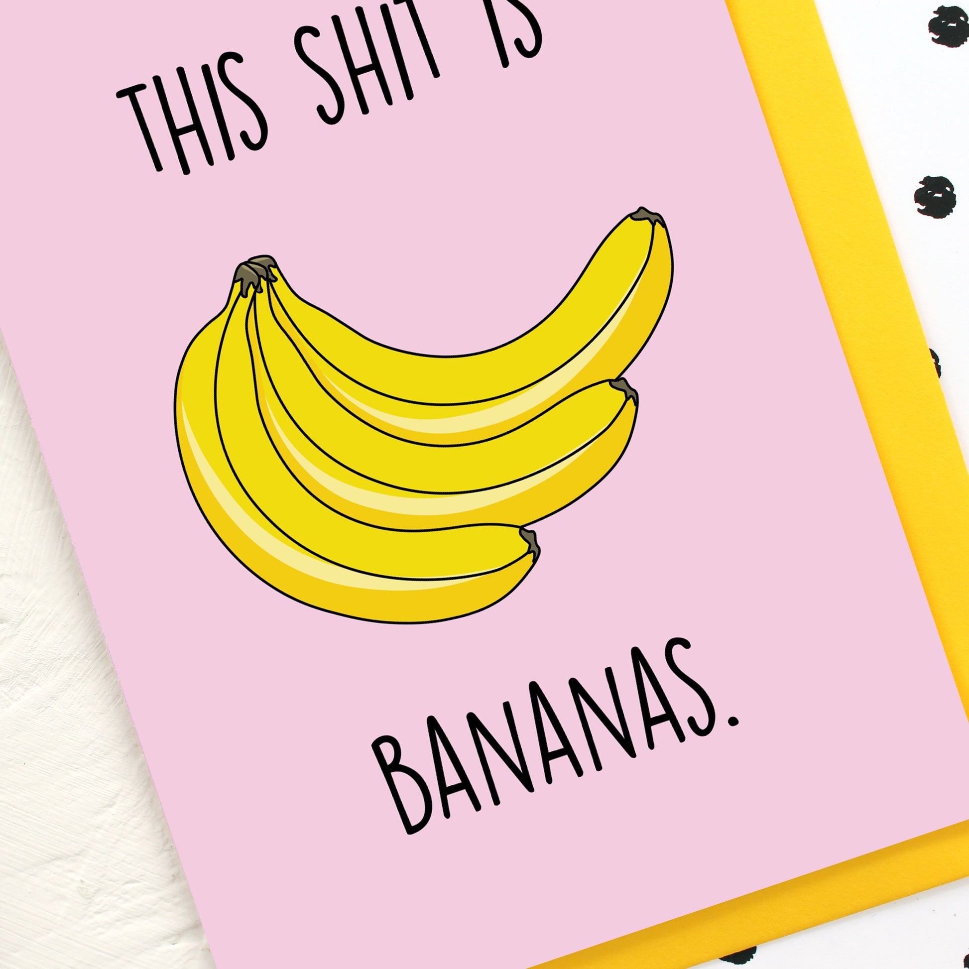 A bunch of bananas on a pink background