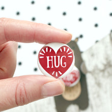 Load image into Gallery viewer, Close up of hug badge