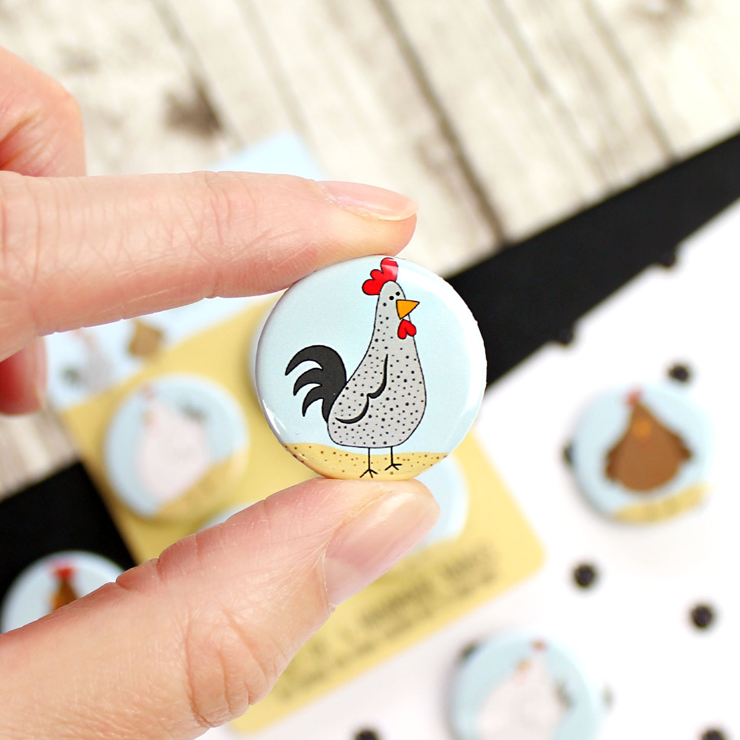 Grey cockerel badge