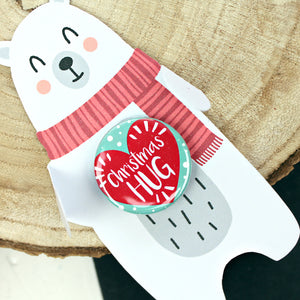 Christmas hug heart badge on a polar bear backing