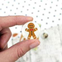 Load image into Gallery viewer, A gingerbread man with icing decorations