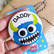 Load image into Gallery viewer, Blue monster badge with green horns and googly eyes