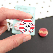 Load image into Gallery viewer, A skull and cross bone with a red and white striped background