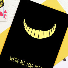 Load image into Gallery viewer, Yellow Cheshire Cat smile on black card