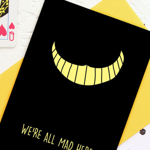 Yellow Cheshire Cat smile on black card